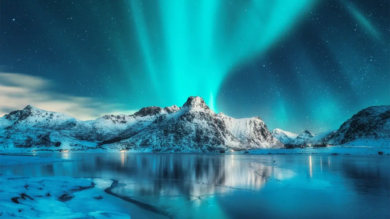 Close up on a plate of mashed potatoes, topped with baked pork chops with cream of mushroom soup, and a side of green beans.