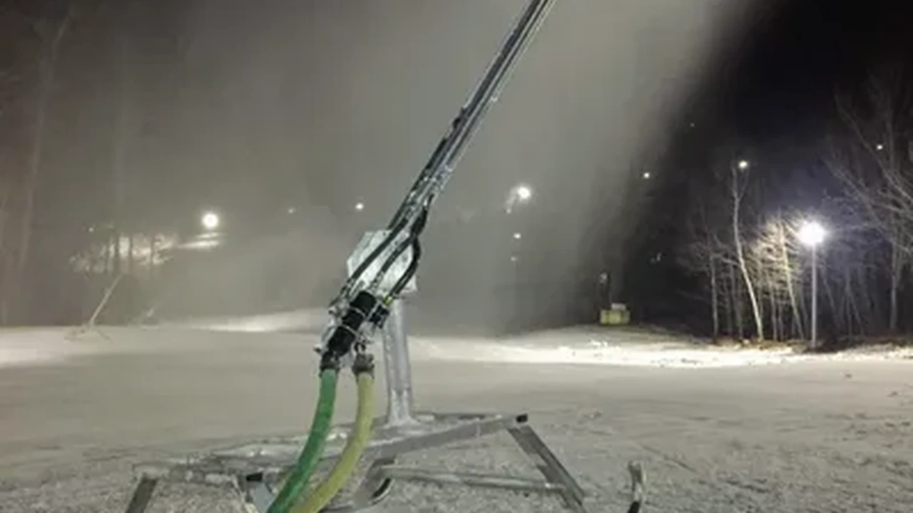 Close up on a plate of mashed potatoes, topped with baked pork chops with cream of mushroom soup, and a side of green beans.