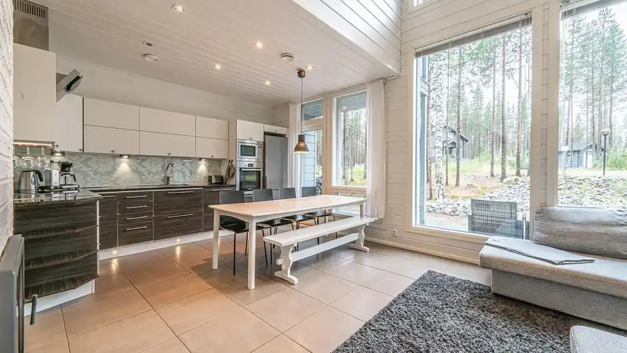 Close up on a plate of mashed potatoes, topped with baked pork chops with cream of mushroom soup, and a side of green beans.
