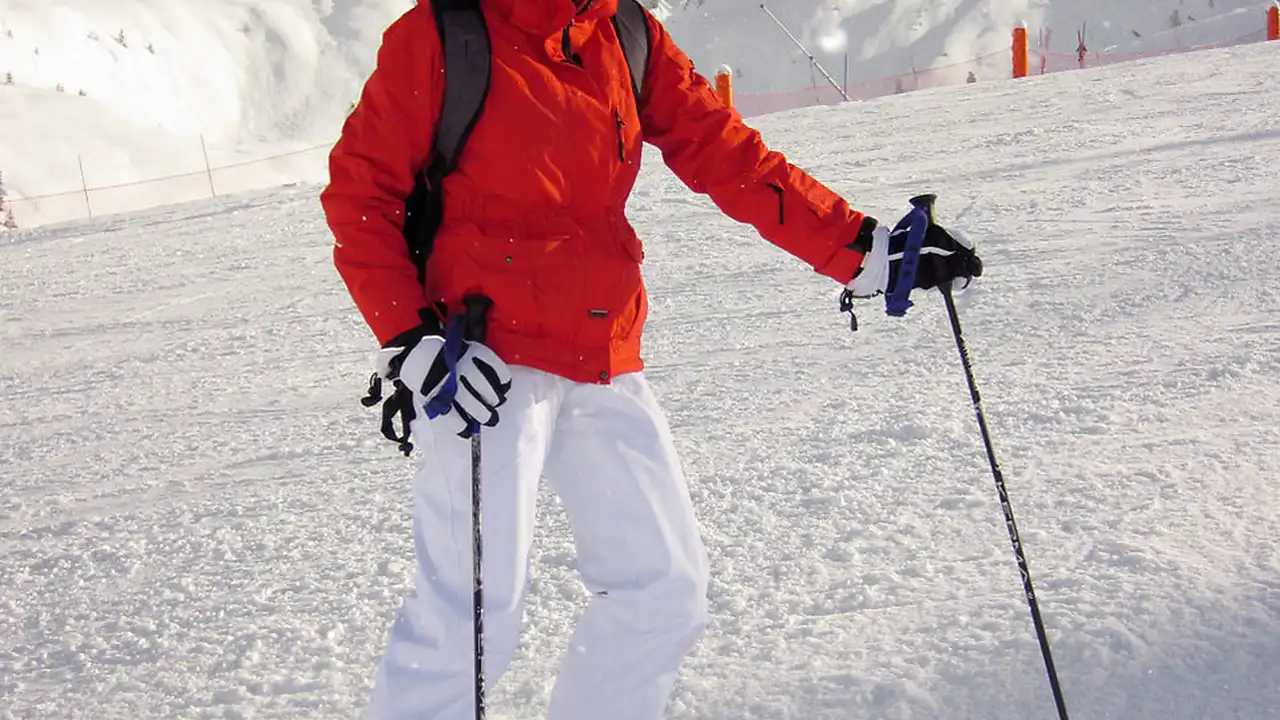 Close up on a plate of mashed potatoes, topped with baked pork chops with cream of mushroom soup, and a side of green beans.