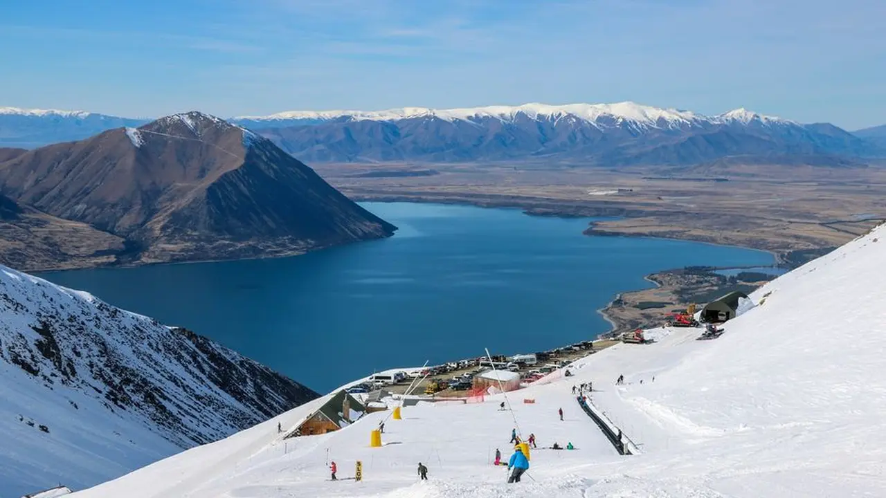 Close up on a plate of mashed potatoes, topped with baked pork chops with cream of mushroom soup, and a side of green beans.