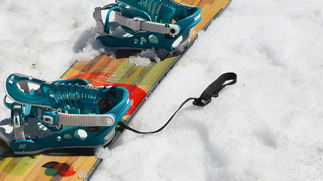 Close up on a plate of mashed potatoes, topped with baked pork chops with cream of mushroom soup, and a side of green beans.